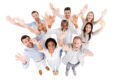 Successful business team. Top view of positive diverse group of people in smart casual wear looking at camera and stretching out their hands while standing close to each other