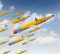 Planning leader business concept as a businessman on a giant yellow pencil with a harness guiding a group of followers as a metaphor for creative leadership guidance and development of a team strategy.